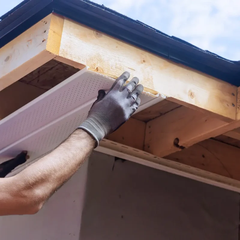 soffit-repair-close-up-of-a-man-installing-new-soffit-materials-on-a-home